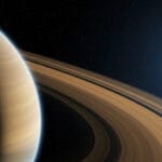 A breathtaking view showcases Saturn's rings, a celestial body, and a distant moon